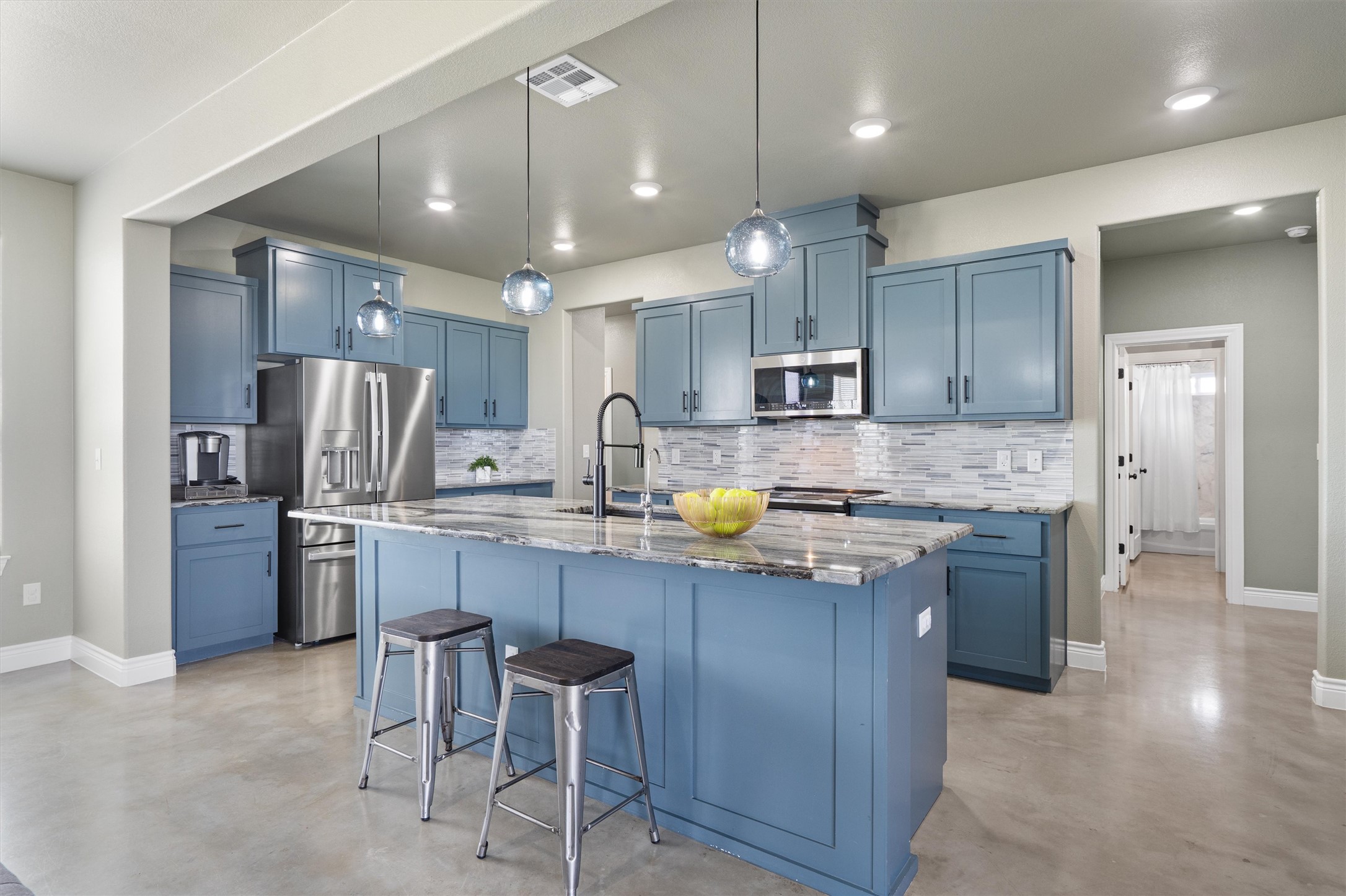 15073 Armstrong Estates Road Salado, TX 76571 - Photo 3 of 40 a kitchen with stainless steel appliances granite countertop a sink refrigerator and cabinets
