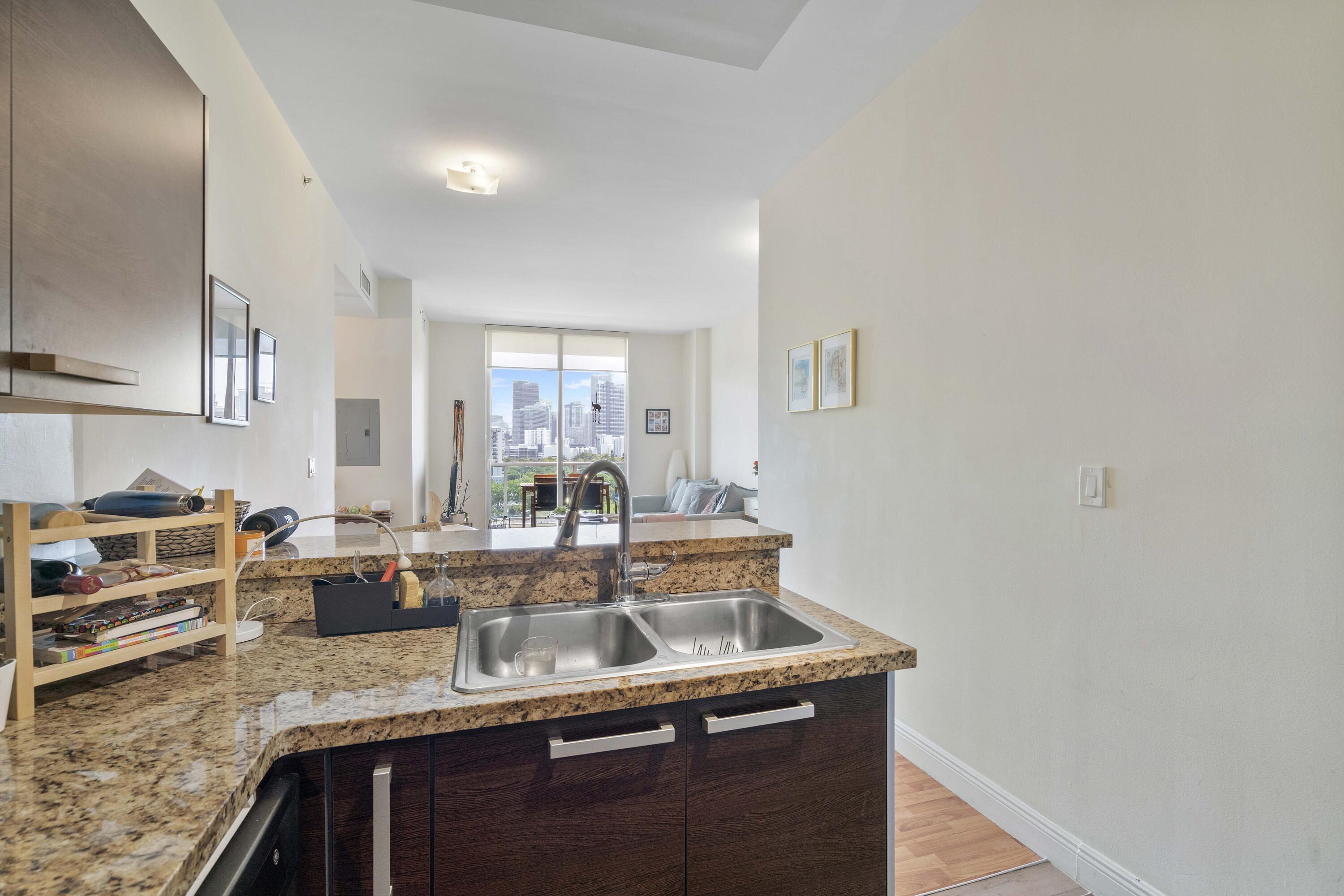 2525 Southwest 3rd Avenue, Unit 807 Miami, FL 33129 - Photo 20 of 27 a kitchen with granite countertop a sink and cabinets