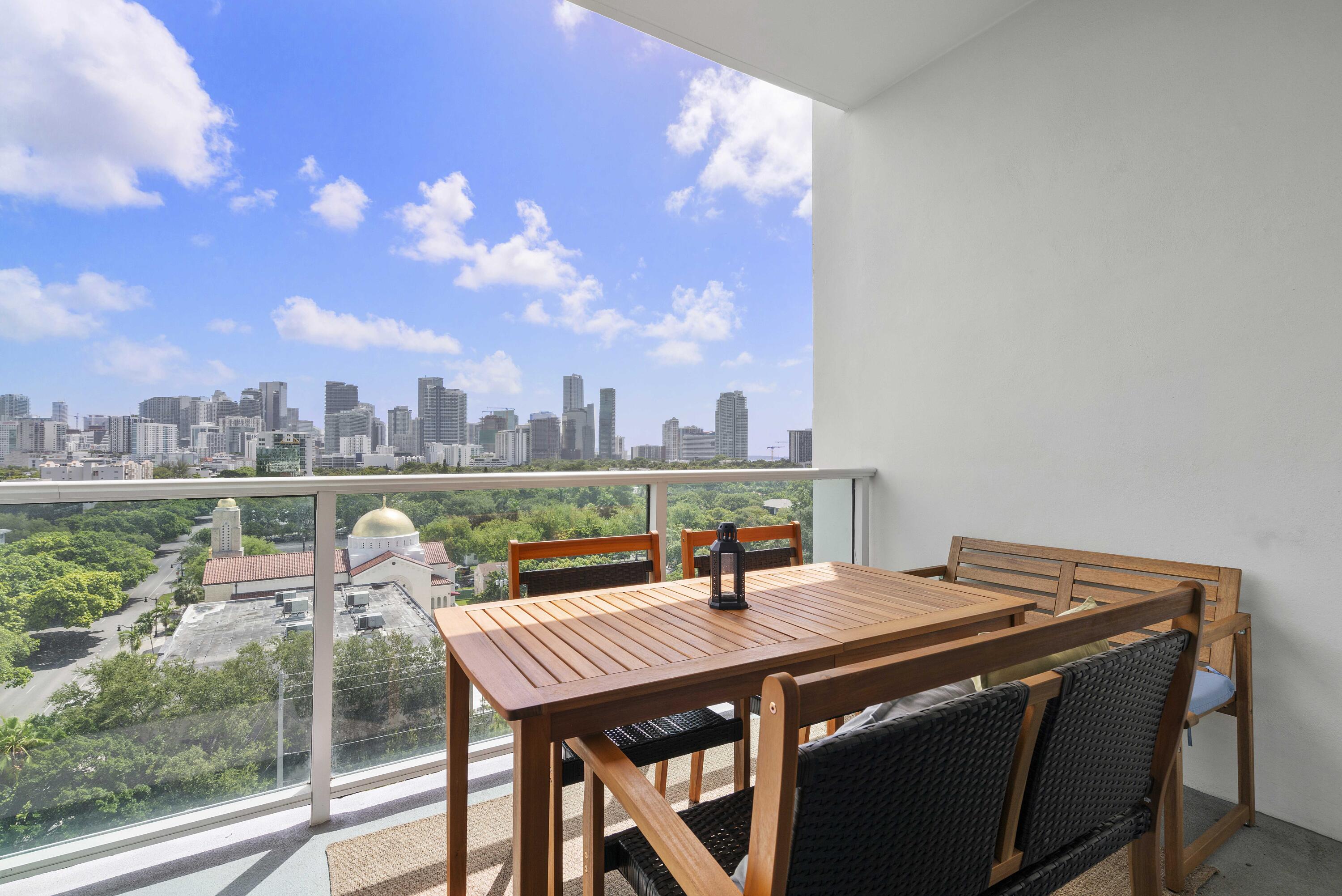 2525 Southwest 3rd Avenue, Unit 807 Miami, FL 33129 - Photo 2 of 27 a view of a terrace with furniture and a view of lake
