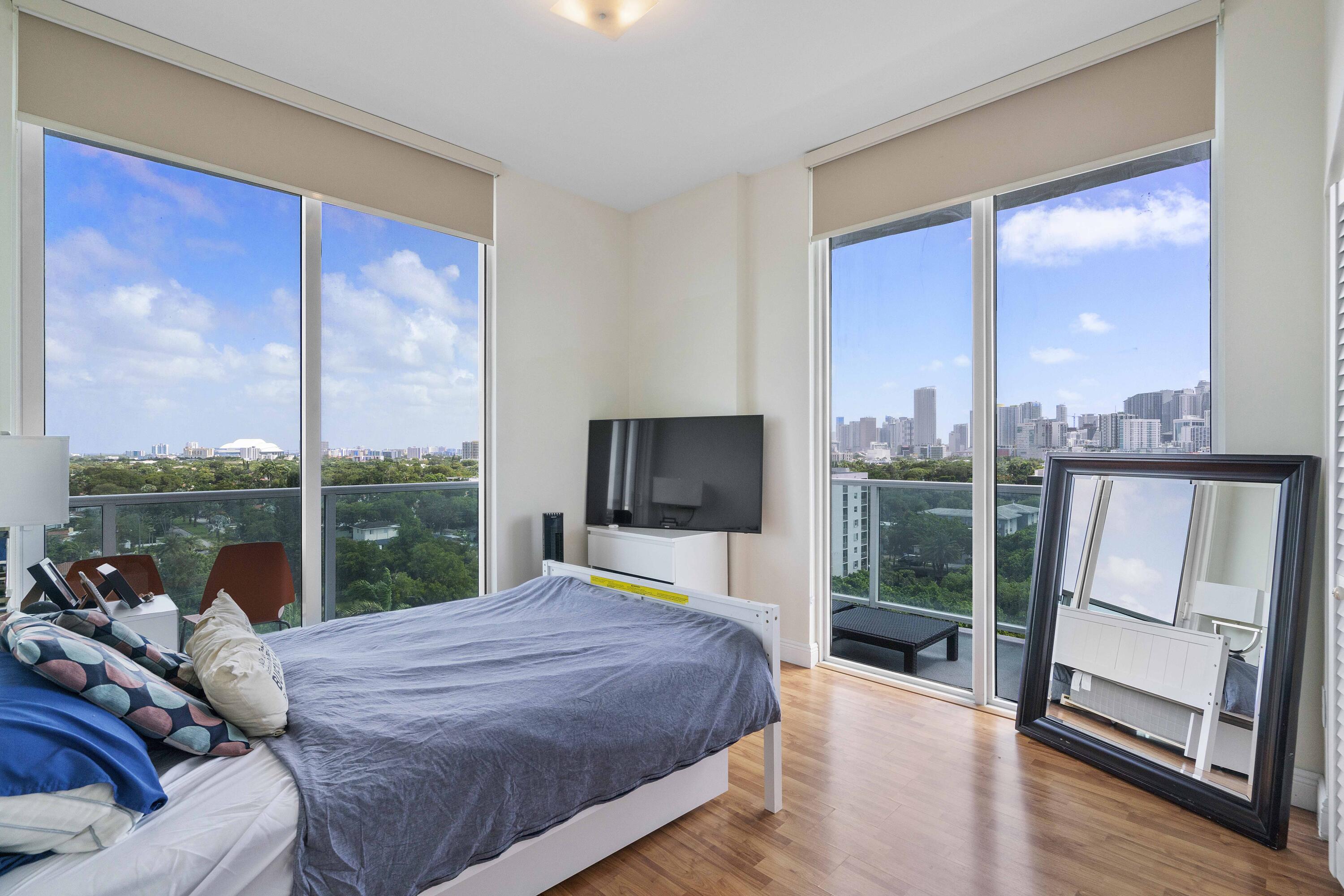 2525 Southwest 3rd Avenue, Unit 807 Miami, FL 33129 - Photo 23 of 27 a bedroom with a large window and a bed