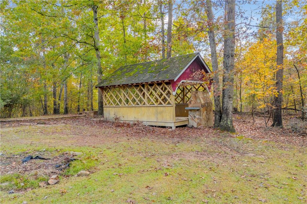 450 Stagecoach Way Danielsville, GA 30633 - Photo 16 of 65 a backyard of a house with a large tree and wooden fence