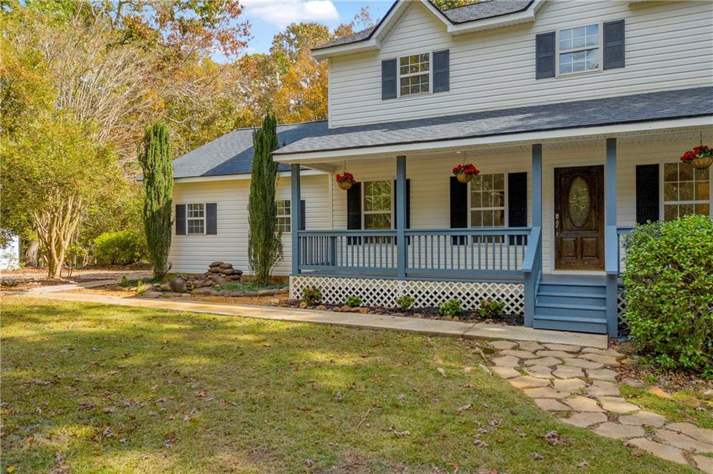450 Stagecoach Way Danielsville, GA 30633 - Photo 19 of 65 a front view of a house with a garden