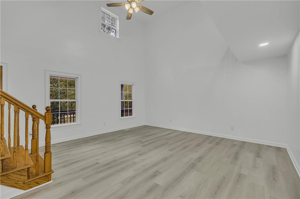 450 Stagecoach Way Danielsville, GA 30633 - Photo 26 of 65 a view of an empty room with wooden floor and a window