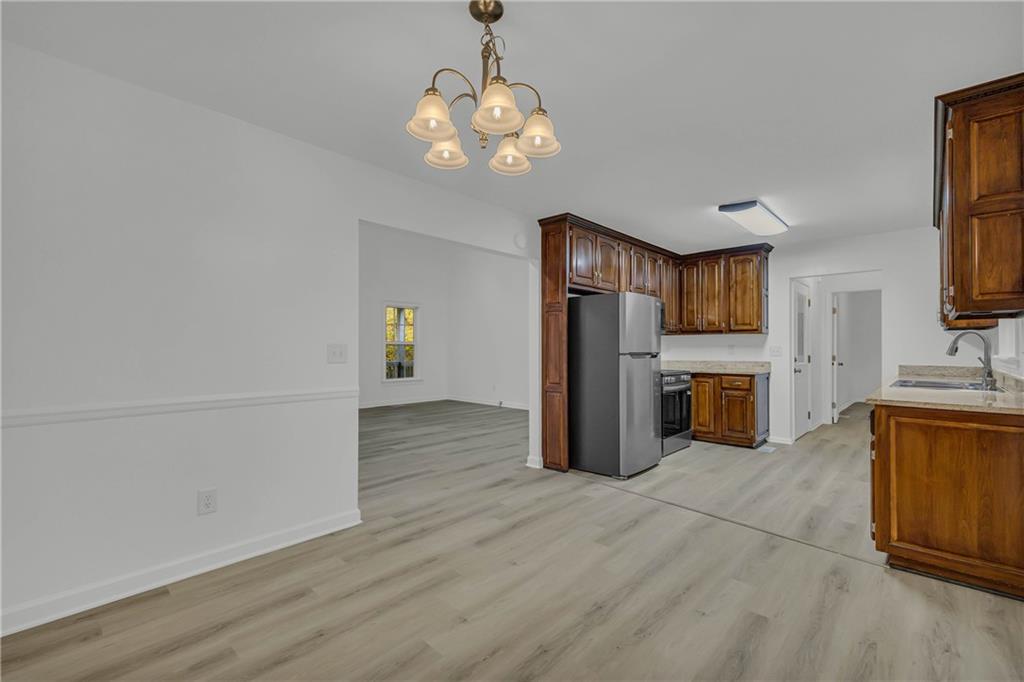 450 Stagecoach Way Danielsville, GA 30633 - Photo 27 of 65 a view of a kitchen with a sink dishwasher cabinets and wooden floor