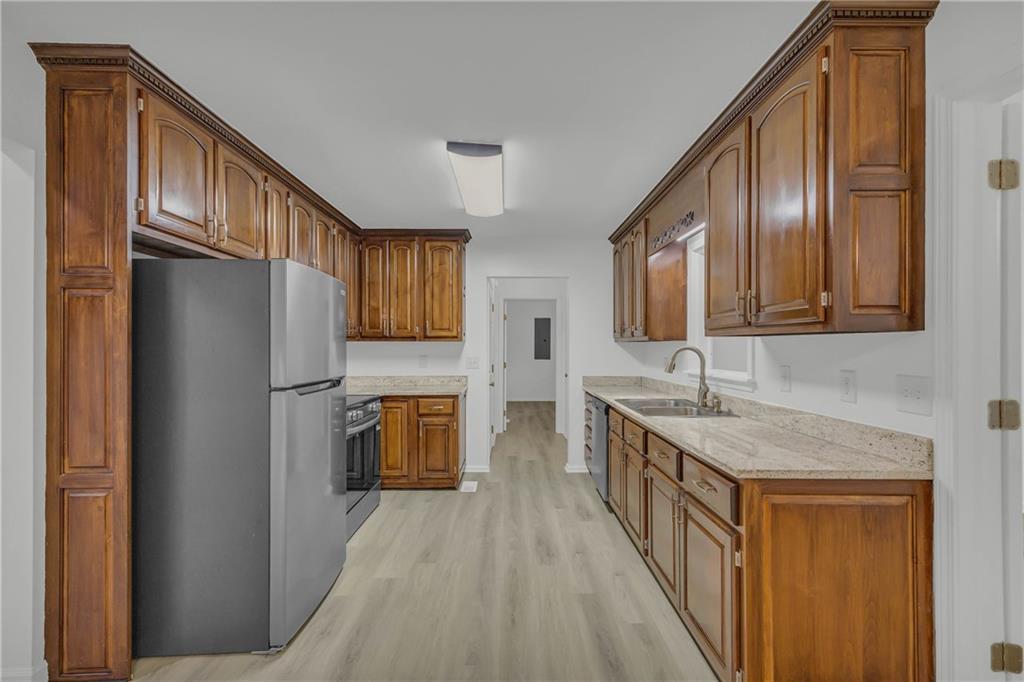 450 Stagecoach Way Danielsville, GA 30633 - Photo 28 of 65 a kitchen with stainless steel appliances granite countertop a refrigerator a stove and a sink with wooden floor