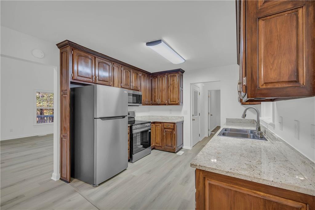 450 Stagecoach Way Danielsville, GA 30633 - Photo 29 of 65 a kitchen with a refrigerator sink and cabinets