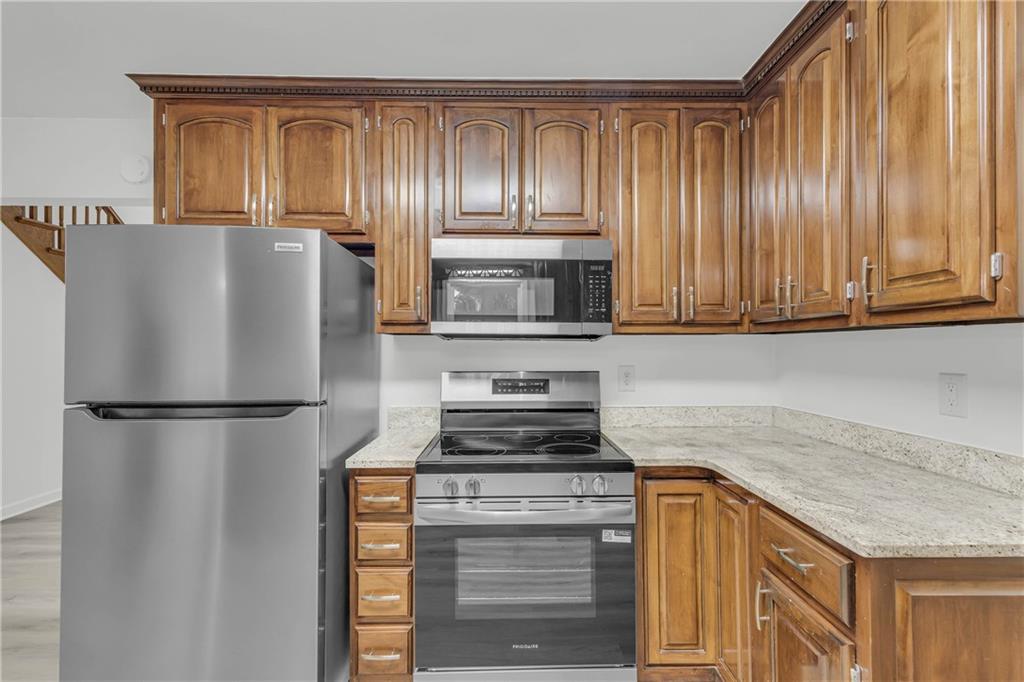 450 Stagecoach Way Danielsville, GA 30633 - Photo 32 of 65 a kitchen with refrigerator and cabinets
