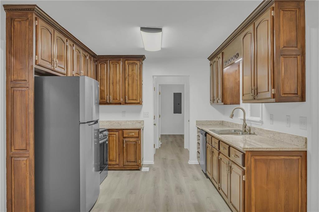 450 Stagecoach Way Danielsville, GA 30633 - Photo 33 of 65 a kitchen with stainless steel appliances granite countertop a refrigerator a stove a sink and dishwasher with wooden floor