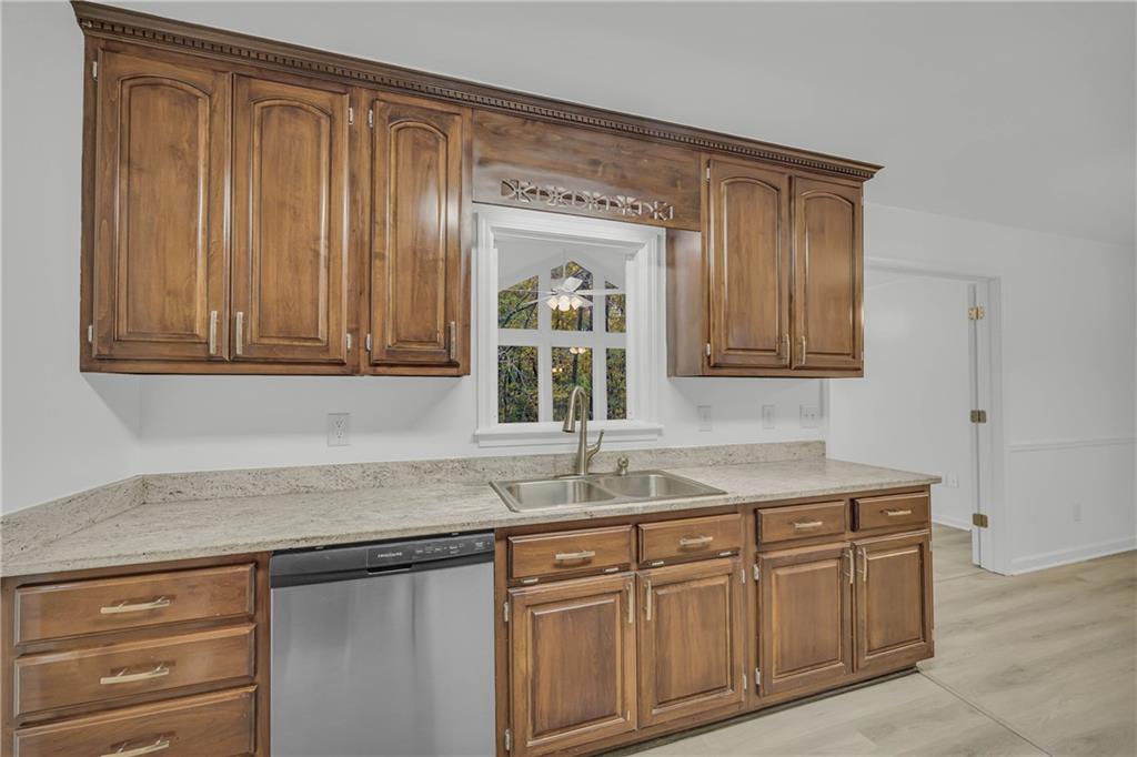 450 Stagecoach Way Danielsville, GA 30633 - Photo 34 of 65 a kitchen with granite countertop cabinets sink and window
