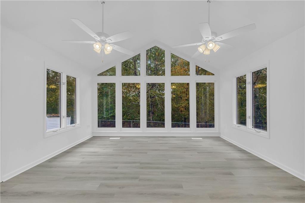 450 Stagecoach Way Danielsville, GA 30633 - Photo 36 of 65 a view of an empty room with wooden floor and a window
