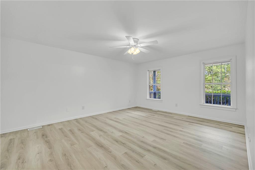 450 Stagecoach Way Danielsville, GA 30633 - Photo 40 of 65 an empty room with windows and fan