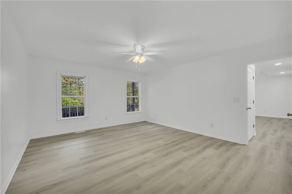 450 Stagecoach Way Danielsville, GA 30633 - Photo 43 of 65 wooden floor in an empty room with a window