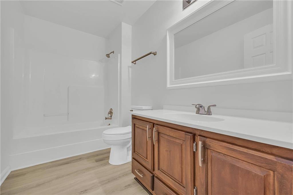 450 Stagecoach Way Danielsville, GA 30633 - Photo 53 of 65 a bathroom with a granite countertop sink a toilet and a bathtub