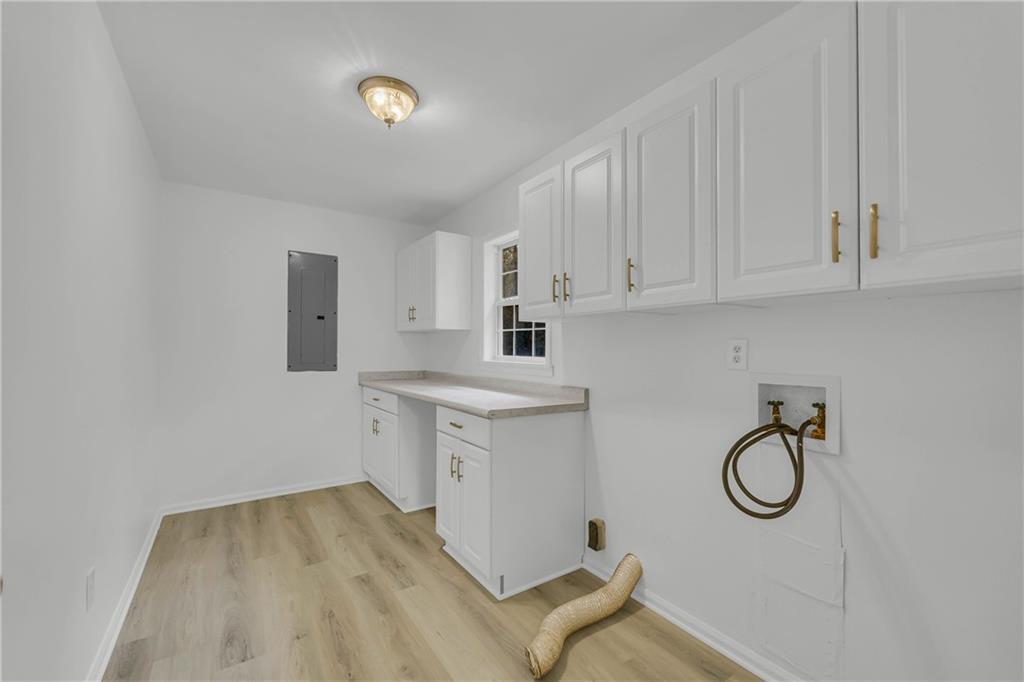 450 Stagecoach Way Danielsville, GA 30633 - Photo 54 of 65 a kitchen with cabinets appliances and a wooden floor