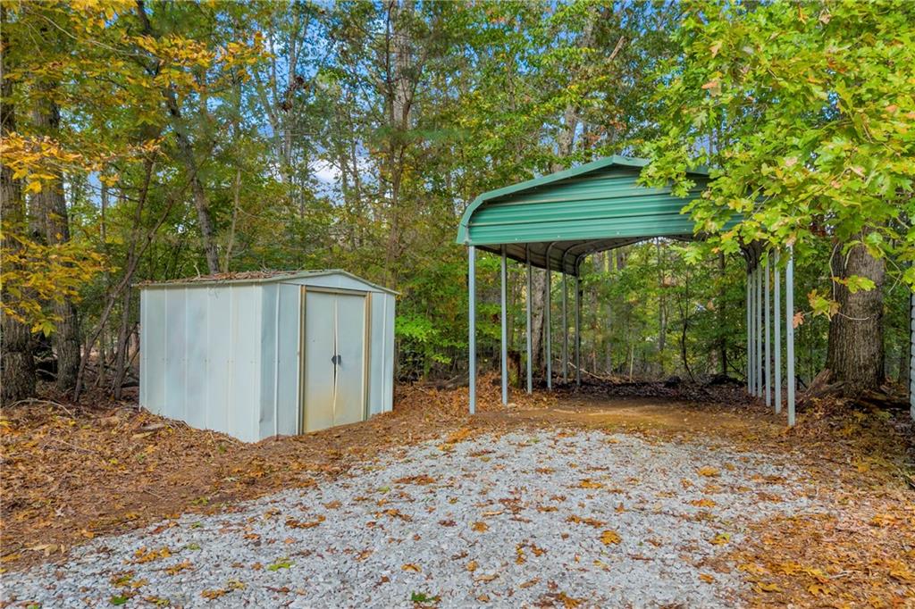 450 Stagecoach Way Danielsville, GA 30633 - Photo 61 of 65 a backyard of a house with a table and chairs under an umbrella
