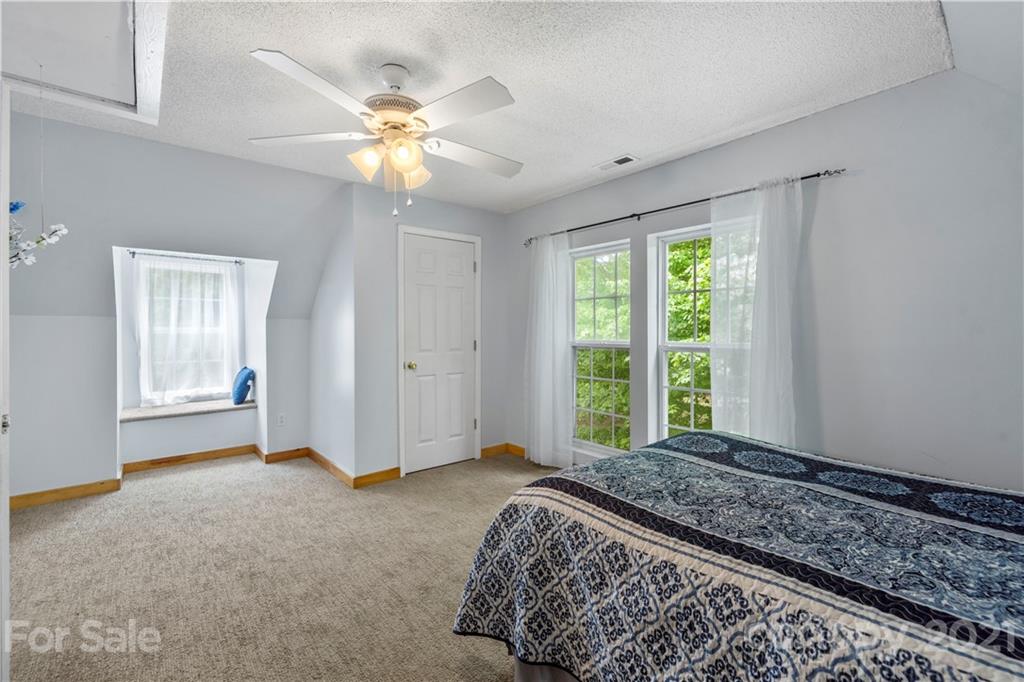 553 Sandifer Road York, SC 29745 - Photo 23 of 24 a bedroom with a large bed and a chandelier