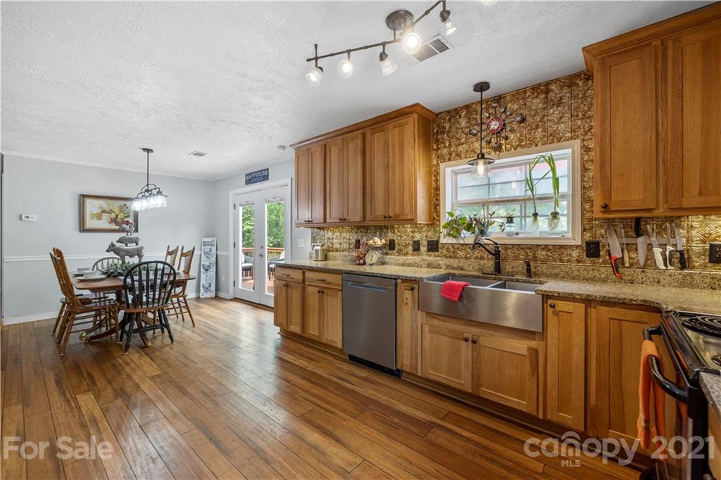 553 Sandifer Road York, SC 29745 - Photo 8 of 24 a kitchen with stainless steel appliances wooden floors dining table and chairs