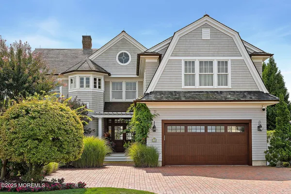 a living room with fireplace furniture and a chandelier