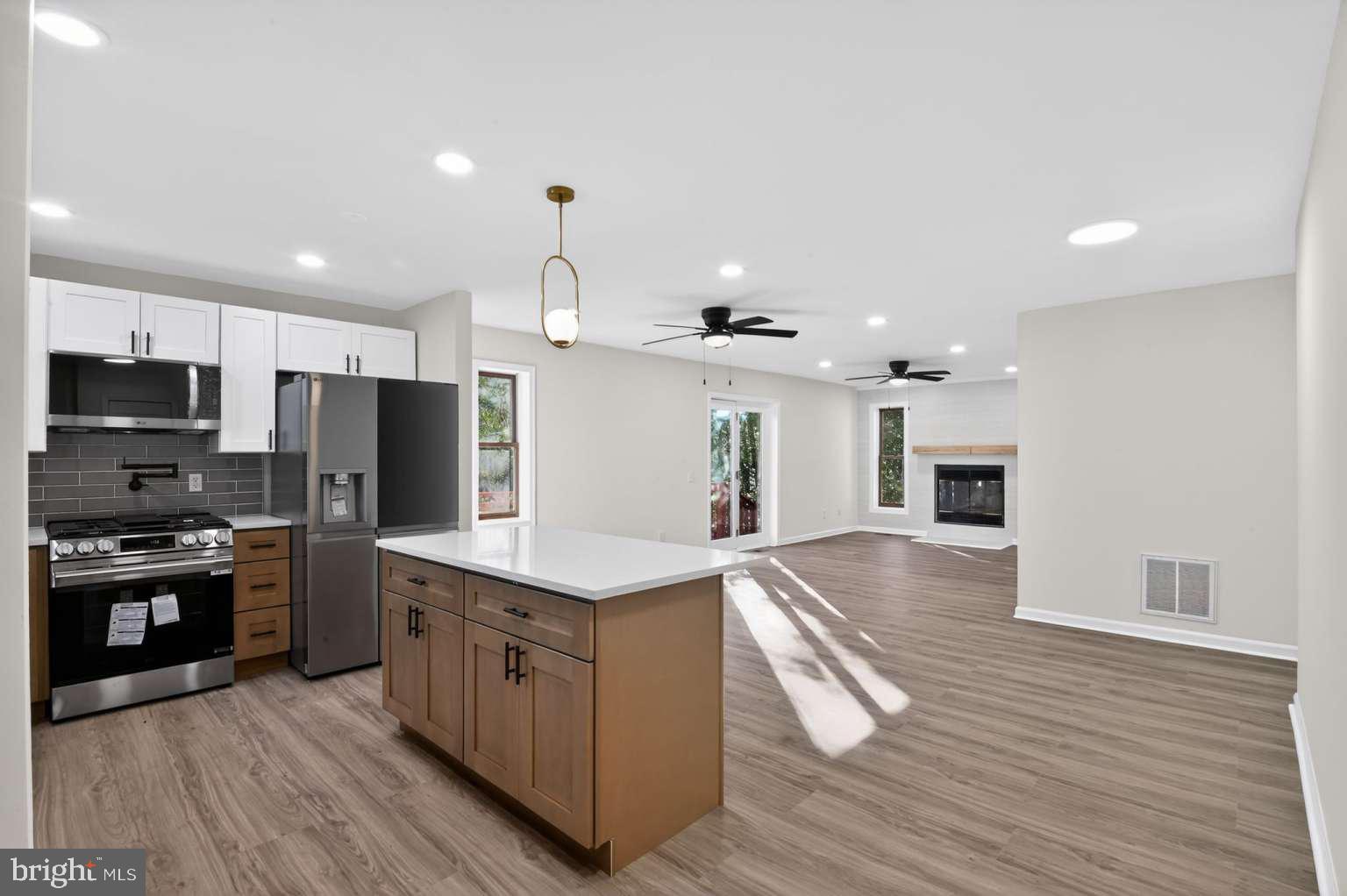 271 Academy Road Woodbine, NJ 08270 - Photo 17 of 37 a large kitchen with stainless steel appliances kitchen island granite countertop a stove a sink and a refrigerator