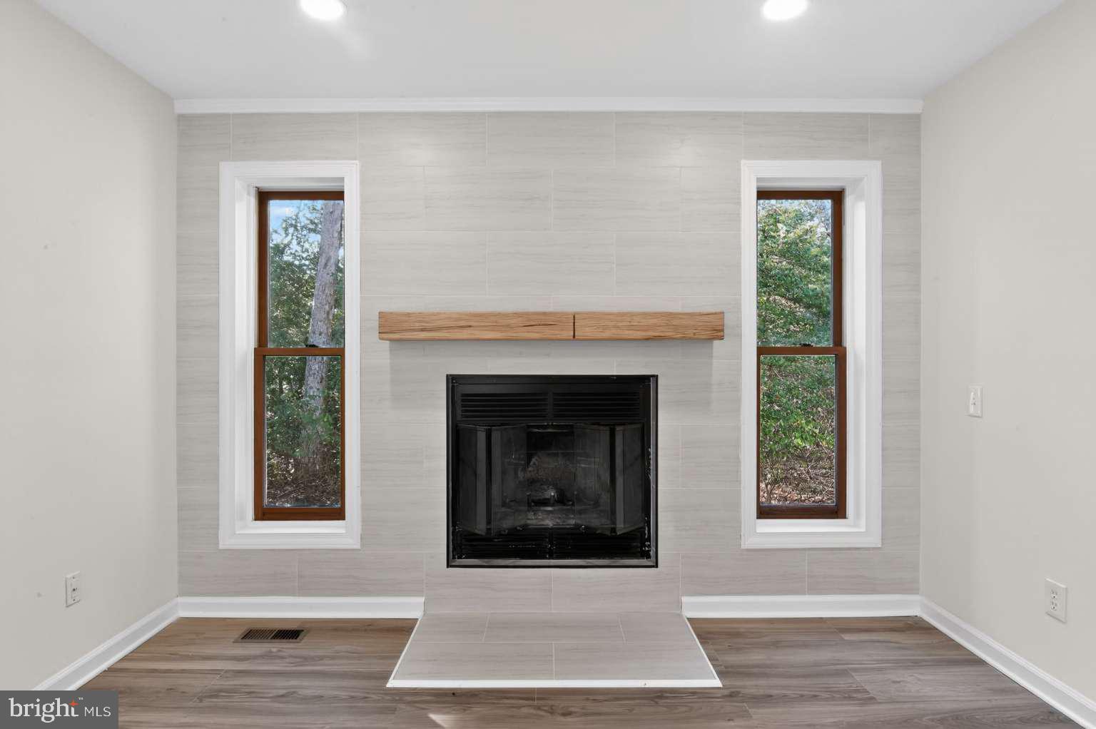 271 Academy Road Woodbine, NJ 08270 - Photo 20 of 37 a living room with a fireplace and window