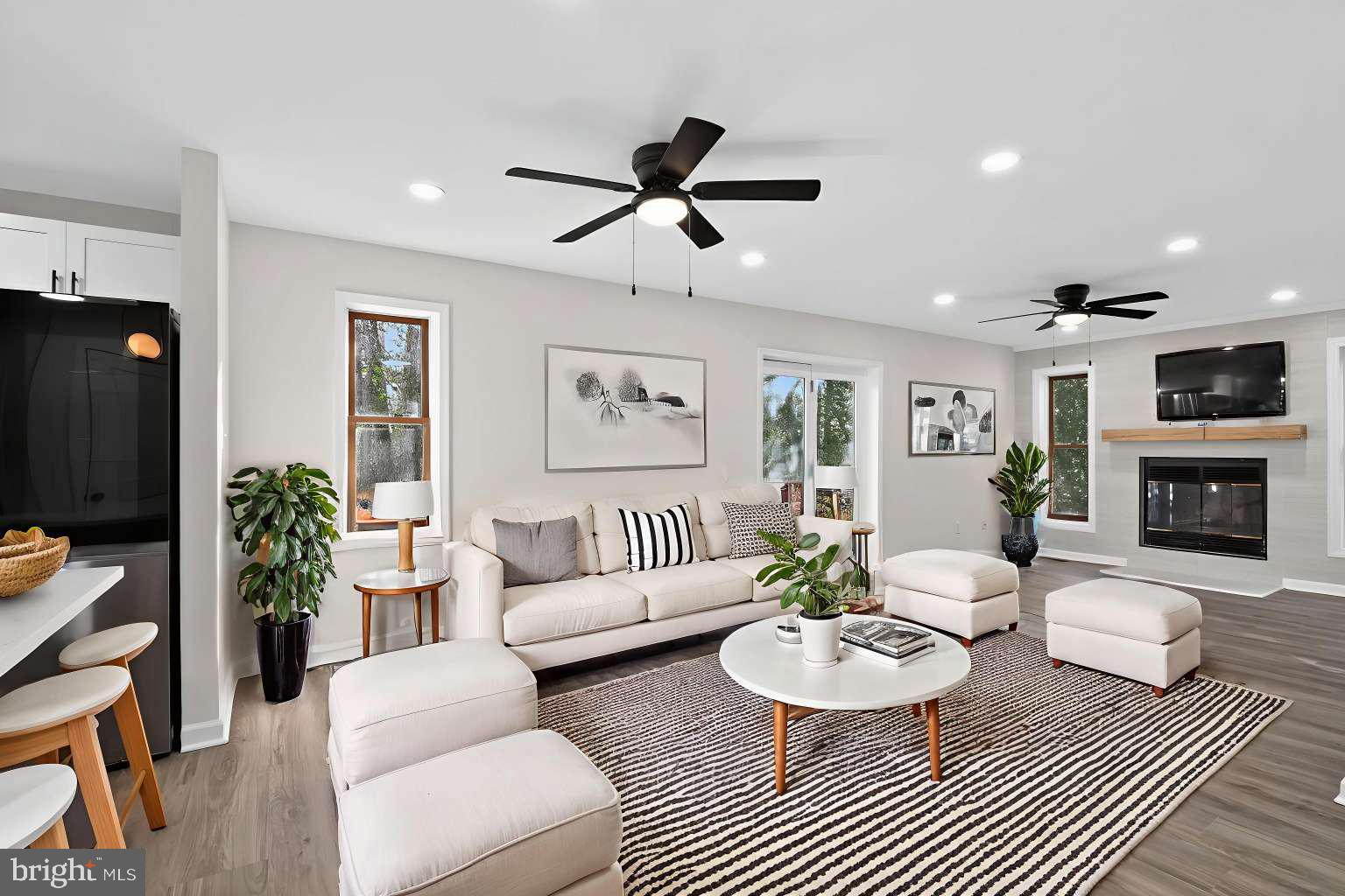 271 Academy Road Woodbine, NJ 08270 - Photo 9 of 37 a living room with furniture a fireplace and a flat screen tv
