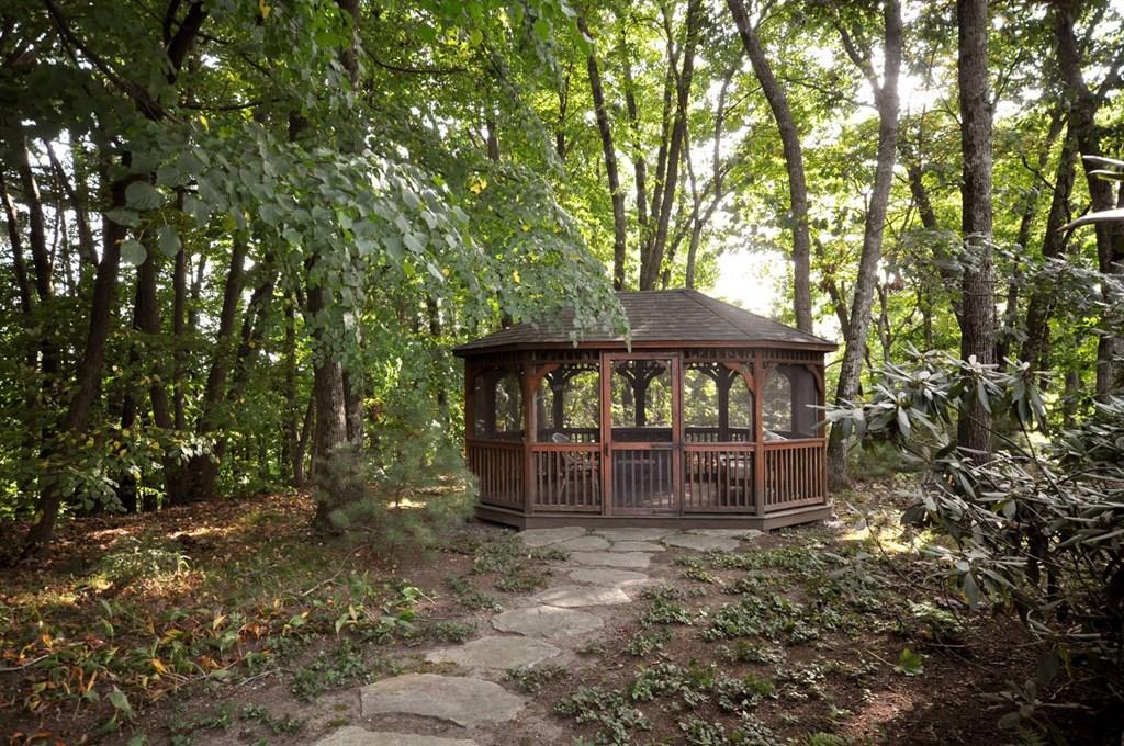 103 Revolutionary Road Concord, MA 01742 - Photo 20 of 39 a backyard of a house with table and chairs