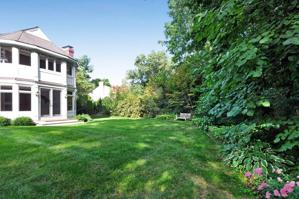 103 Revolutionary Road Concord, MA 01742 - Photo 22 of 39 a view of a big yard with plants and large trees