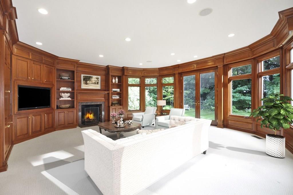 103 Revolutionary Road Concord, MA 01742 - Photo 23 of 39 a living room with furniture a flat screen tv and a fireplace