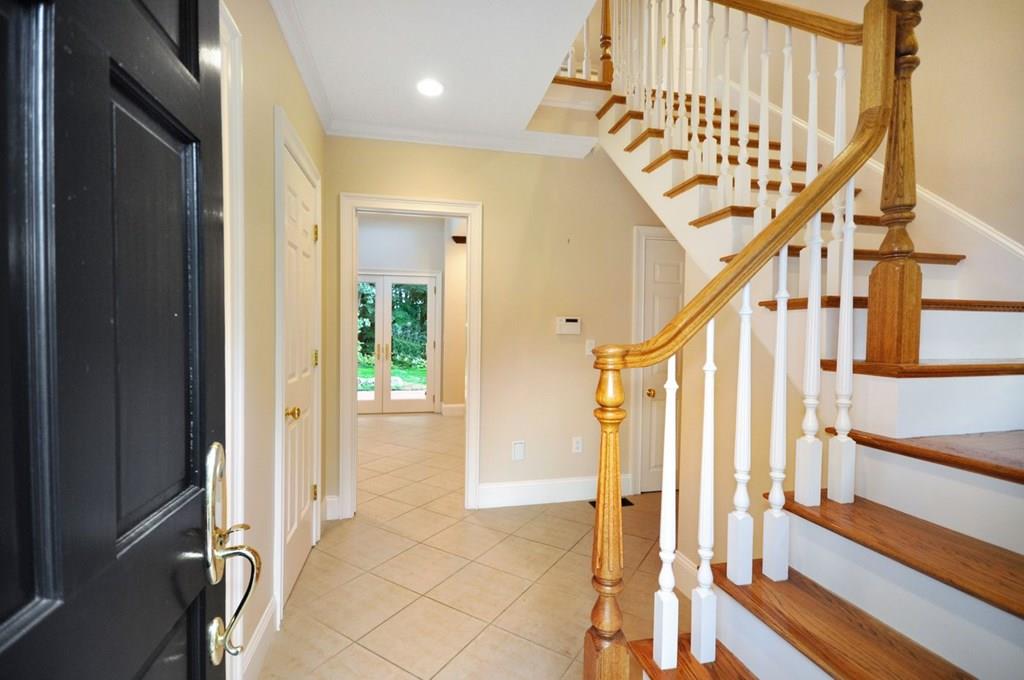 103 Revolutionary Road Concord, MA 01742 - Photo 28 of 39 a view of an entryway with wooden floor and door