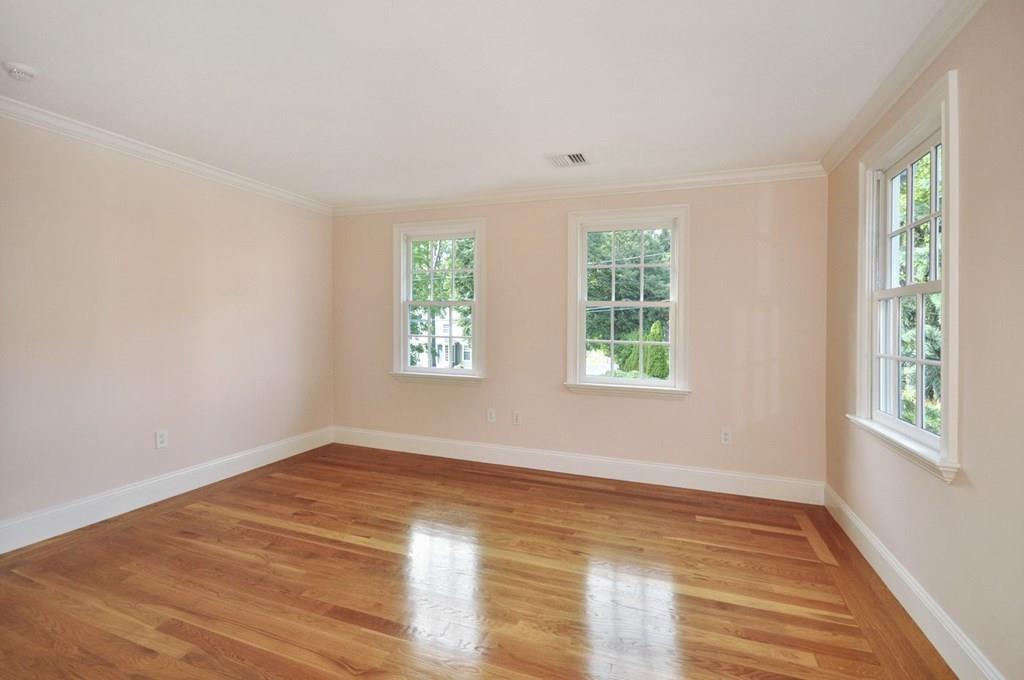 103 Revolutionary Road Concord, MA 01742 - Photo 34 of 39 a view of an empty room with wooden floor and a window