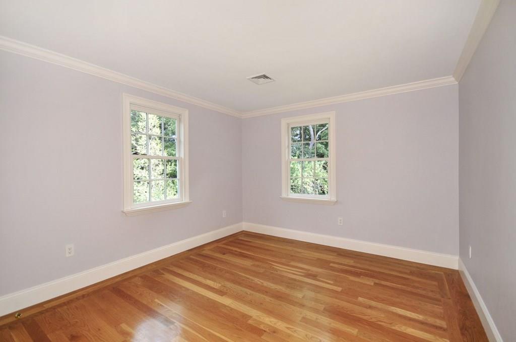 103 Revolutionary Road Concord, MA 01742 - Photo 36 of 39 a view of an empty room with wooden floor and a window