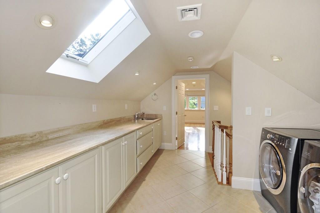 103 Revolutionary Road Concord, MA 01742 - Photo 37 of 39 a view of a hallway with washer and dryer