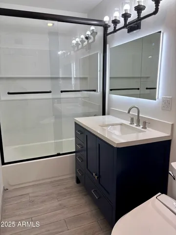 a bathroom with a sink vanity and a mirror
