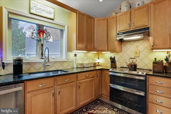 a kitchen with sink dining table and chairs