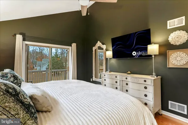 a bedroom with a large bed and a window