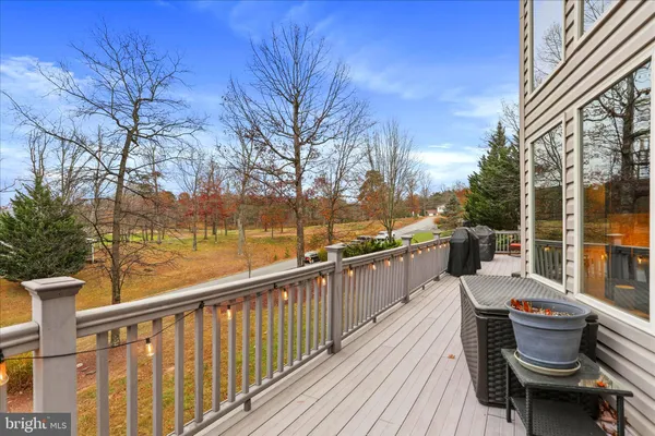 a view of a roof deck with couches and wooden floor