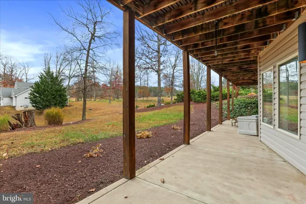 a view of a house with a yard and sitting area