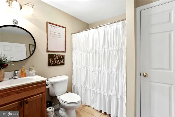 a bathroom with a toilet a sink and a mirror