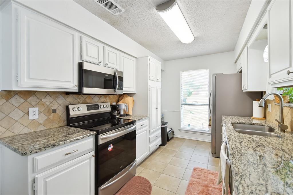 3129 Regency Carrollton, TX 75007 - Photo 13 of 29 a kitchen with a stove microwave and refrigerator