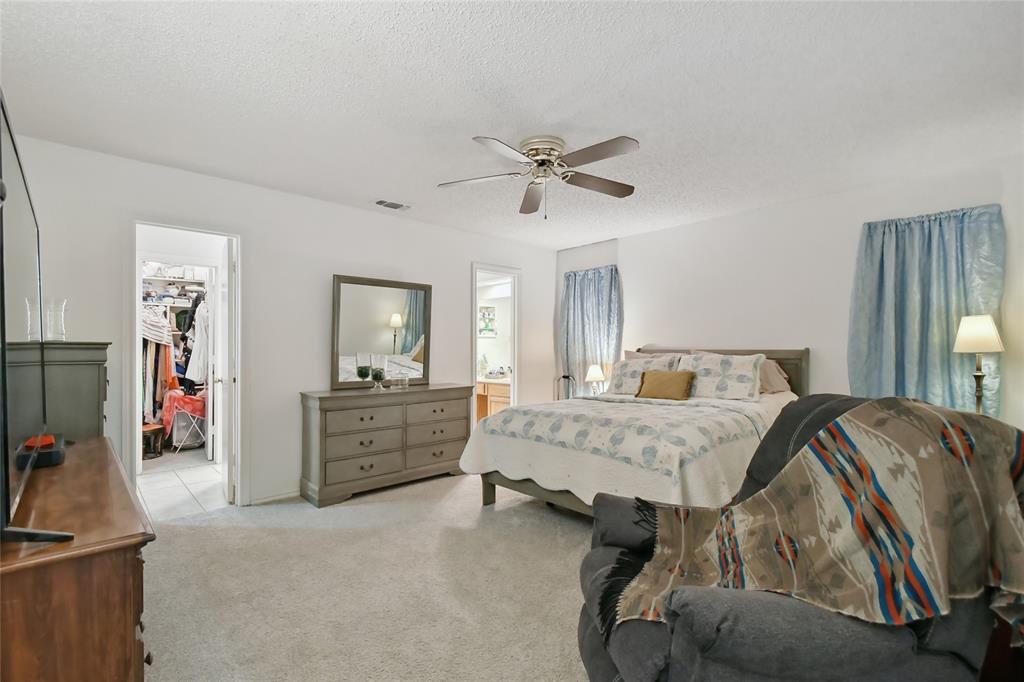 3129 Regency Carrollton, TX 75007 - Photo 16 of 29 a bed room with a bed and a chandelier
