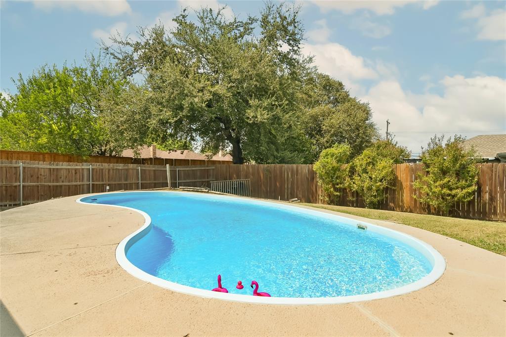 3129 Regency Carrollton, TX 75007 - Photo 22 of 29 a view of a swimming pool with a yard