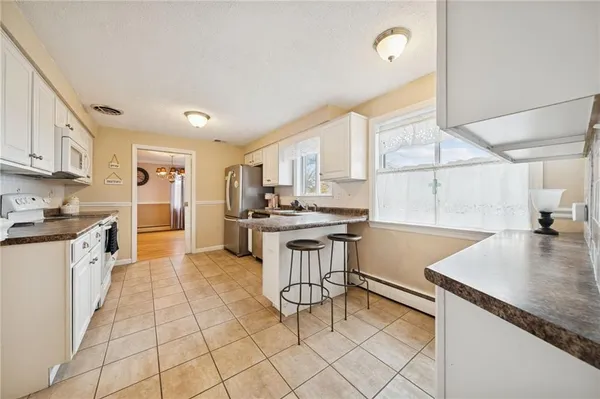 a kitchen with a sink cabinets and window