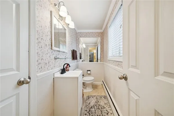 a bathroom with a sink mirror and a toilet
