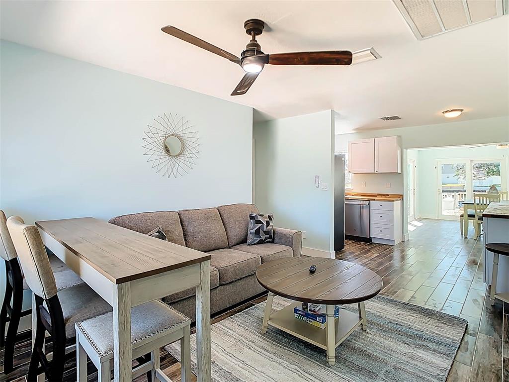 4984 Cedarbrook Lane Hernando Beach, FL 34607 - Photo 11 of 65 a living room with furniture and kitchen view