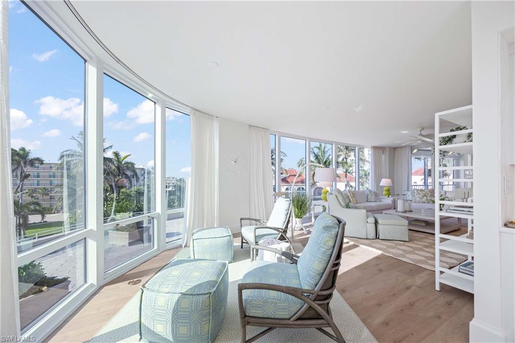 3971 Gulf Shore Boulevard North, Unit 401 Naples, FL 34103 - Photo 14 of 50 a living room with furniture and a large window