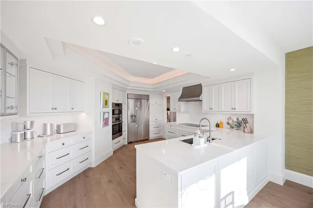 a kitchen with cabinets a sink and appliances