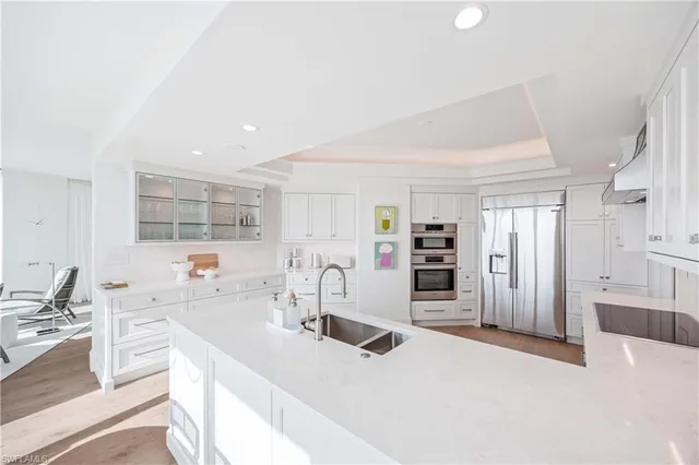 a kitchen with stainless steel appliances kitchen island granite countertop a sink and cabinets