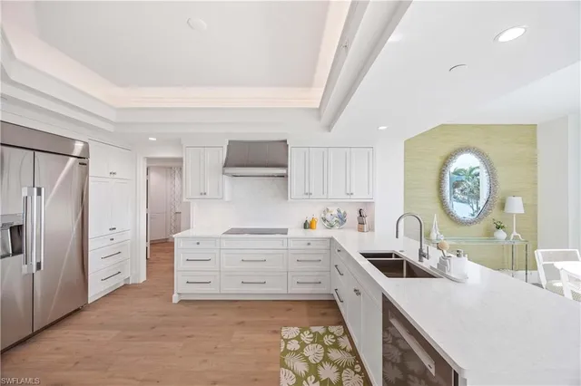 a kitchen with stainless steel appliances a stove a sink and a refrigerator