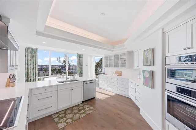 a large white kitchen with cabinets