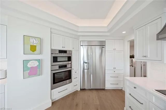 a kitchen with stainless steel appliances a refrigerator and cabinets